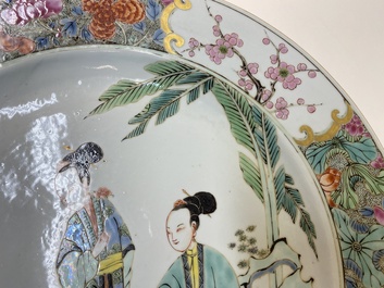 A Chinese famille rose dish with two ladies and a boy in a garden, Yongzheng