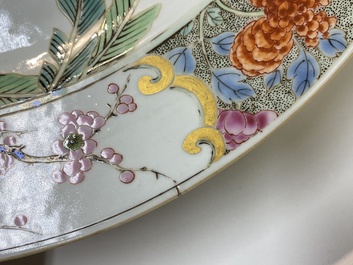A Chinese famille rose dish with two ladies and a boy in a garden, Yongzheng