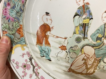 A Chinese famille rose dish with two ladies and a boy in a garden, Yongzheng