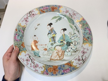 A Chinese famille rose dish with two ladies and a boy in a garden, Yongzheng