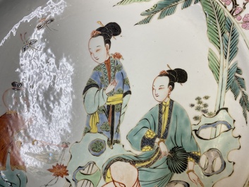 A Chinese famille rose dish with two ladies and a boy in a garden, Yongzheng