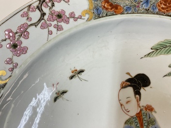 A Chinese famille rose dish with two ladies and a boy in a garden, Yongzheng