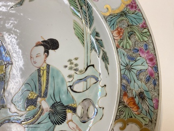 A Chinese famille rose dish with two ladies and a boy in a garden, Yongzheng