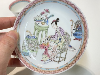 A pair of Chinese famille rose cups and saucers with a lady and a boy, Yongzheng