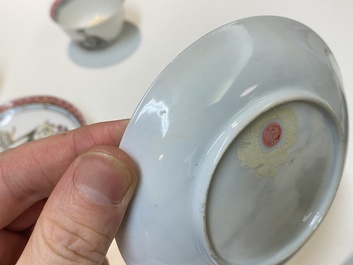 A pair of Chinese famille rose cups and saucers with a lady and a boy, Yongzheng