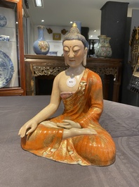 A Chinese famille rose figure of Buddha, Qianlong mark, 19/20th C.