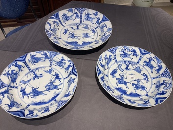 Three large deep Chinese blue and white 'hunting scene' dishes, Chenghua mark, Kangxi