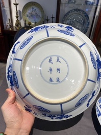 Three large deep Chinese blue and white 'hunting scene' dishes, Chenghua mark, Kangxi