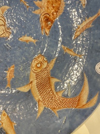 A large Chinese iron-red-decorated blue-ground 'carps' dish, 19th C.