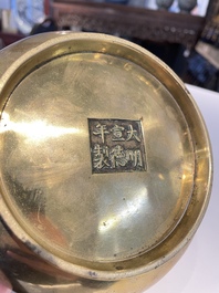 A Chinese bronze elephant-head-handled censer, Xuande mark, Kangxi/Qianlong