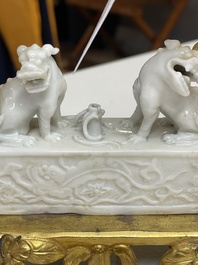 A Chinese Dehua blanc de Chine joss stick holder with French gilt bronze candlestick mounts, Kangxi and 18/19th C.