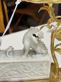 A Chinese Dehua blanc de Chine joss stick holder with French gilt bronze candlestick mounts, Kangxi and 18/19th C.