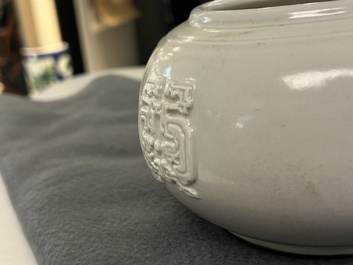 A Chinese white-glazed relief-molded bowl, Qianlong mark, 19th C.