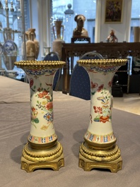 Une paire de vases en porcelaine de Chine famille rose aux montures en bronze dor&eacute; et une chope &agrave; sujet mandarin, Qianlong