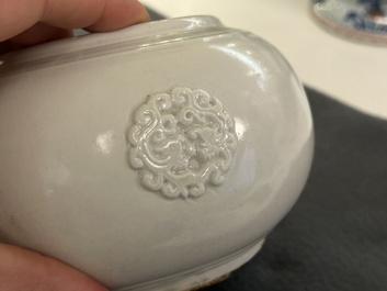 A Chinese white-glazed relief-molded bowl, Qianlong mark, 19th C.