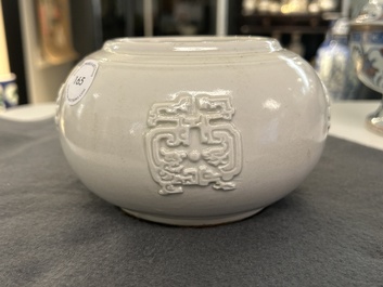 A Chinese white-glazed relief-molded bowl, Qianlong mark, 19th C.