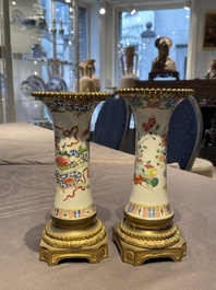 Une paire de vases en porcelaine de Chine famille rose aux montures en bronze dor&eacute; et une chope &agrave; sujet mandarin, Qianlong