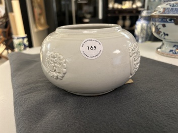 A Chinese white-glazed relief-molded bowl, Qianlong mark, 19th C.
