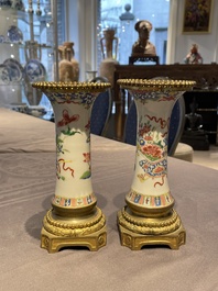 Une paire de vases en porcelaine de Chine famille rose aux montures en bronze dor&eacute; et une chope &agrave; sujet mandarin, Qianlong