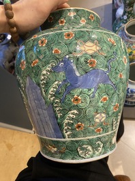 A pair of Chinese famille verte 'galloping horses' vases and covers, 19th C.