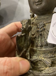 A Chinese bronze Buddha and a peach-shaped incense burner, Ming and Qing