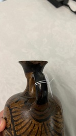 An Etruskian 'aryballos' portrait ewer and a 'patera' dish with black geometrical design, 4th C. b.C.