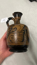 An Etruskian 'aryballos' portrait ewer and a 'patera' dish with black geometrical design, 4th C. b.C.