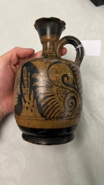 An Etruskian 'aryballos' portrait ewer and a 'patera' dish with black geometrical design, 4th C. b.C.
