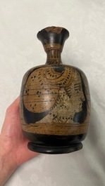 An Etruskian 'aryballos' portrait ewer and a 'patera' dish with black geometrical design, 4th C. b.C.