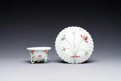 A Chinese famille rose relief-decorated cup and saucer, Yongzheng
