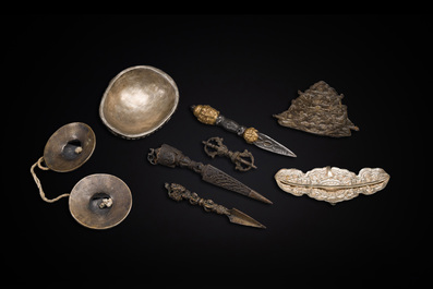 Four Tibetan bronze and wooden phurbas, a 'kapala' or skull-bowl, a pair of brass tingsha and two silver ornaments,  19th C.