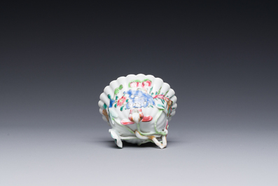 A Chinese famille rose relief-decorated cup and saucer, Yongzheng