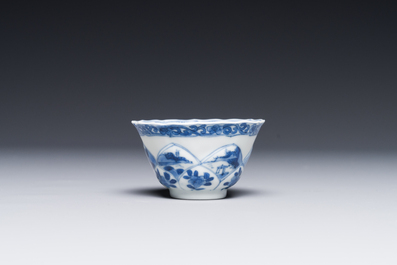 Four Chinese blue and white saucers and an 'erotic' cup, Kangxi