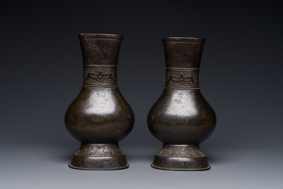 A pair of Chinese bronze 'hu' vases with Taotie design, Song/Yuan