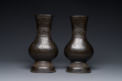 A pair of Chinese bronze 'hu' vases with Taotie design, Song/Yuan