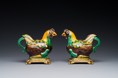 A pair of Chinese sancai-glazed chicken ewers mounted as candleholders with gilt bronze, Kangxi