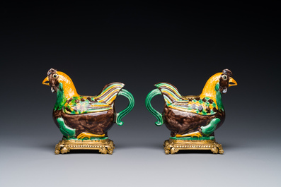A pair of Chinese sancai-glazed chicken ewers mounted as candleholders with gilt bronze, Kangxi