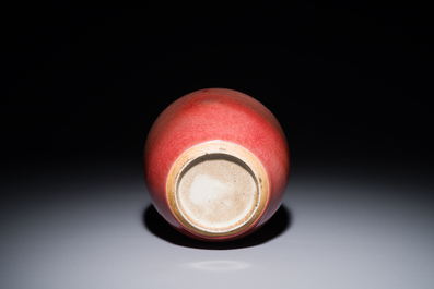 A Chinese monochrome copper-red-glazed ginger jar with a reticulated wooden cover, 18/19th C.