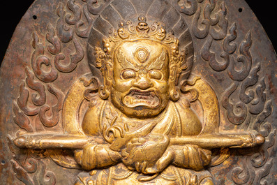 A Tibetan gilt copper 'Mahakala' plaque, 19th C.