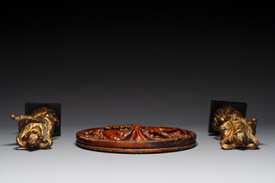 A pair of Chinese gilt-lacquered wooden guardians and a round 'dragon' plaque, 19th C.