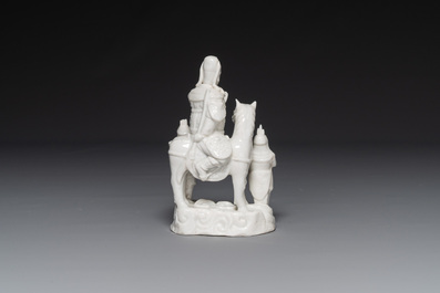 A Chinese Dehua blanc de Chine group of Guandi on horseback and two attendants, Kangxi