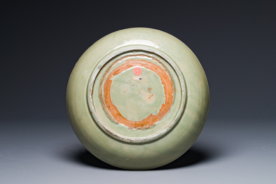 A Chinese Longquan celadon dish with floral anhua design, Ming