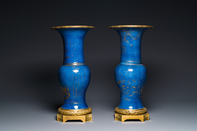 A pair of Chinese gilt-decorated powder-blue 'yenyen' vases with gilt bronze mounts, Kangxi