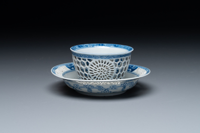 A Chinese blue and white reticulated double-walled cup and saucer, Kangxi
