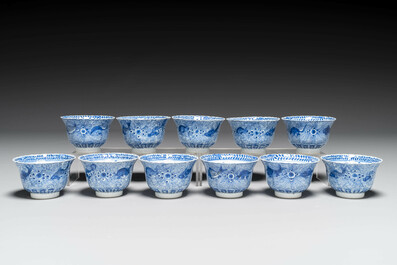 Eleven Chinese blue and white 'crab and fish' cups and saucers, Kangxi mark, Guangxu