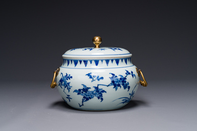 A Chinese blue and white covered bowl with floral design and gilt bronze mounts, Transitional period