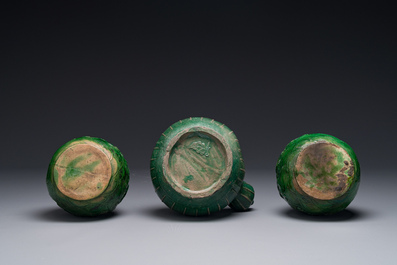 Two Chinese monochrome green-glazed stoneware 'dragon' vases and a kendi, Fujian kiln, late Ming