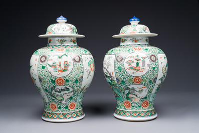 A pair of Chinese famille verte 'bird and flower' vases and covers, Kangxi mark, 19th C.