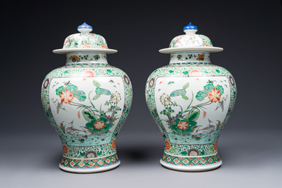 A pair of Chinese famille verte 'bird and flower' vases and covers, Kangxi mark, 19th C.