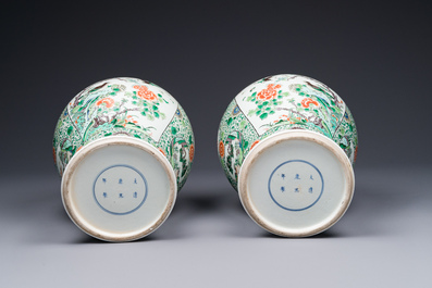 A pair of Chinese famille verte 'bird and flower' vases and covers, Kangxi mark, 19th C.